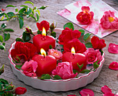 Pink (rose) and heart-shaped candles in flat cake pan