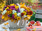 White handle basket with arrangement of chrysanthemum