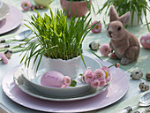 Easter table with Easter grass in cups and pots