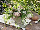 Easter eggs in natural colors covered with pieces of white and brown eggshell