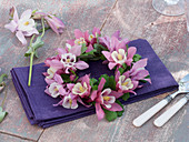 Small wreath Ais aquilegia (Columbine) on violet napkin