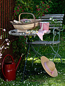Table and chair in the garden next to Weigelia 'Bristol Ruby'