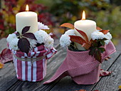 Candles in metal pots with a little water, chrysanthemum