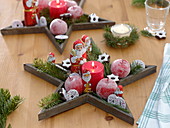 St. Nicholas decoration on wooden stars, sugared apples (Malus)
