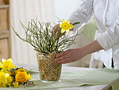 Yellow spring bouquet in straw vase