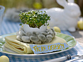 Easter table decoration with cress eggs and pussy willow