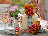 Gift decorated with leaves, rosehip bouquet