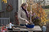 Woman cleaning and oiling garden tools