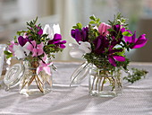 Small bouquets of cyclamen and herbs