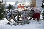 Sled with blanket, sweater, gloves, thermos