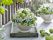 Small green and white bouquets in cups