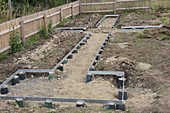 Flowerbeds edged with metal frames on dot foundations