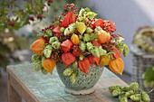 Autumn arrangement of physalis, humulus and pink