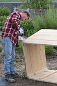 Build a raised flower bed of boards