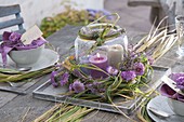 Autumn table decoration with grasses, heather and chrysanthemum flowers