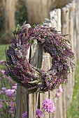 Wreath of Calluna vulgaris (bud-flowering broom heather) on fence