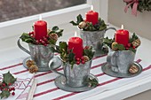 Fast Advent wreath made of 4 zinc cups with saucer on the window