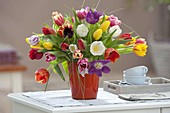 Colorful bouquet with mixed Tulipa in red vase
