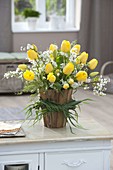 Bouquet with yellow tulipa and spiraea in vase