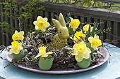 Easter wreath with daffodils and wooden Easter bunny