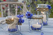Rural table decoration with preserving jars as lanterns
