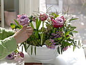 Violet-pink spring arrangement with insertion aid in soup tureen