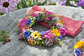Colorful summer wreath of pink (rose), alchemilla (lady's mantle)