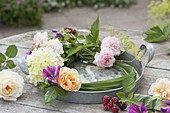 Flower wreath with candles on zinc tray