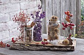 Glasses with autumn fruits put on rustic board