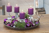 Unusual Advent wreath with candles on inverted glasses