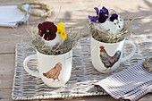 Easter table decoration in cups with chicken decor