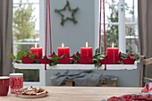 Hanging Christmas wreath on wooden coaster over the table