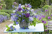 Early summer bouquet in basket vase