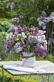 Lush syringa (lilac) bouquet in a cookie jar