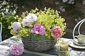 Table decoration with lady's mantle arrangement in the basket