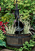 HALF BARREL with Water PUMP AND BUCKET with VARIEGATED Iris LEAVES. CHELSEA 95