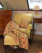 Armchair with blanket, pillows and lampshade