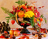 Iron bowl with arrangement of dahlia and physalis