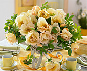 Table setting of pink 'spring gold' (fragrant rose)