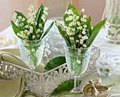 Convallaria (lily of the valley) in wine glasses, metal tray