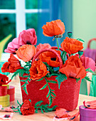 Papaver orientalis (perennial poppy) with vases in a raffia bag