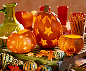 Cucurbita pumpkins hollowed out and decorated with carvings, cut out