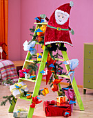 Gnome gifts on and on green wooden ladder, Picea spruce branches