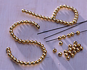 Letters made of wire and gold beads