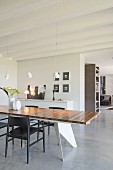 Modern dining table and screed floor in open-plan interior