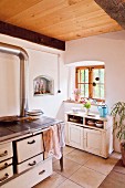 Wood-fired cooker and cabinet in country-house kitchen