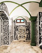 Vaulted ceiling, green column and Baroque, black and white wallpaper in hallway