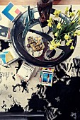 View from above on coffee table with daffodils and book stacks