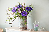 Spring bouquet of blue anemones and magnolia branches