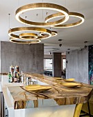 Circular brass light fittings above marble bar